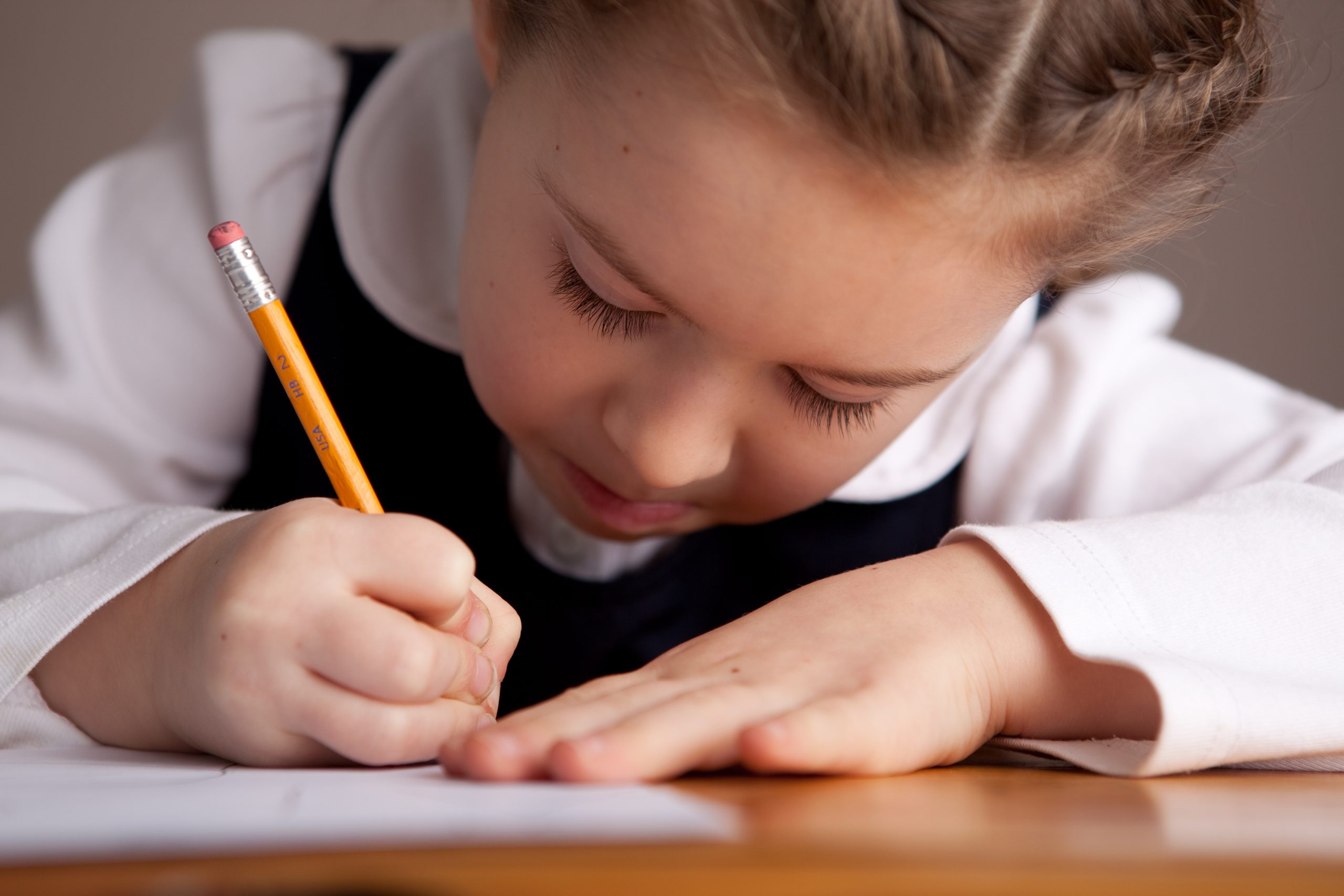 child writing with pencil