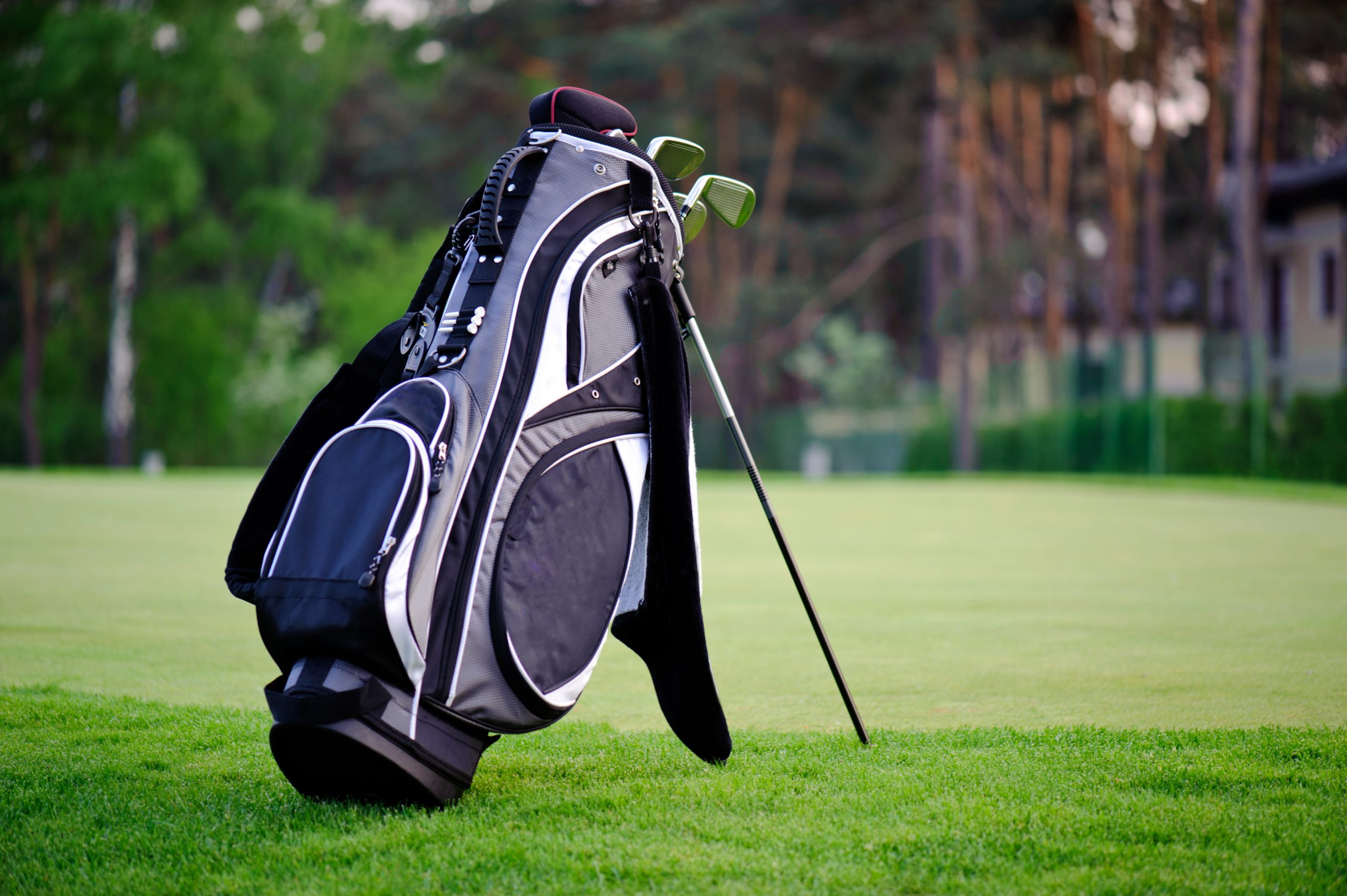 set of golf clubs on green