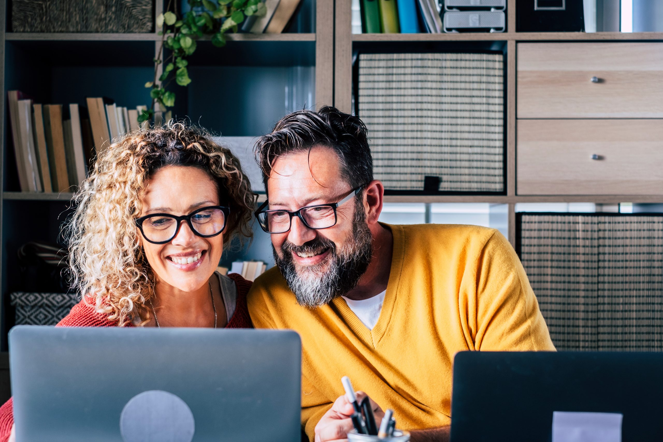 happy adult couple working from home