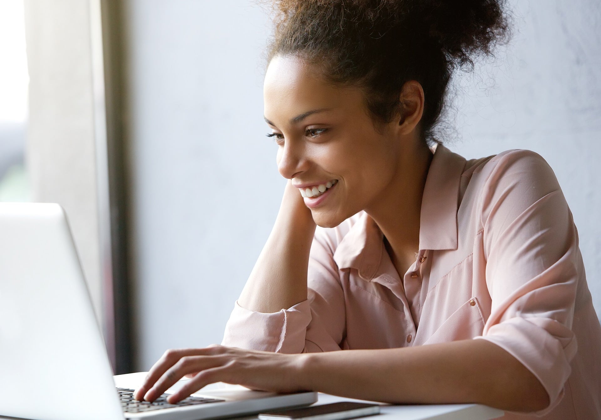 Woman looking online for houses for sale